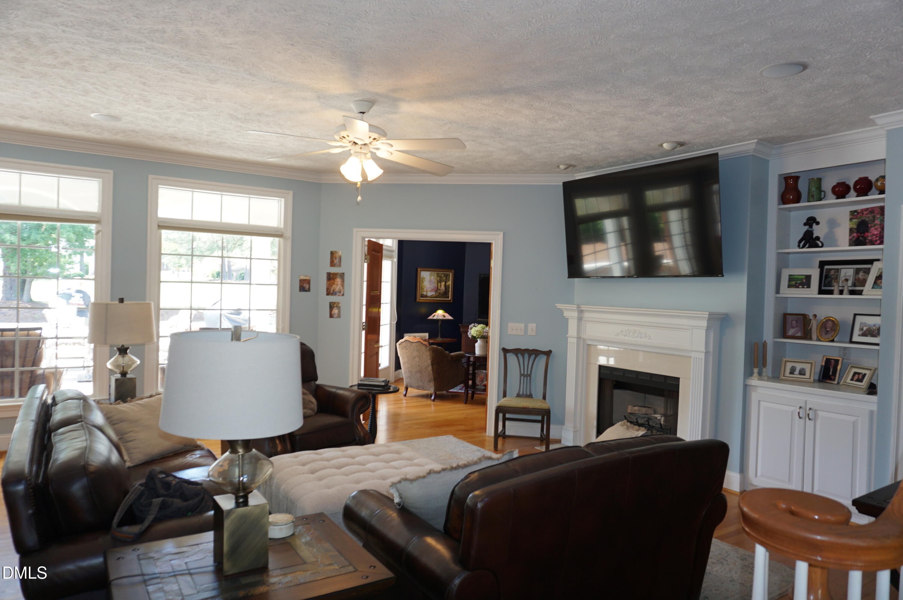 2125 Keith Hills Road Lillington, NC 27546 - Photo 6 of 66 a living room with furniture a flat screen tv and a fireplace