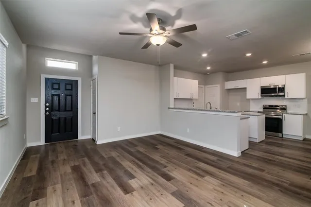 a view of kitchen with sink and refrigerator