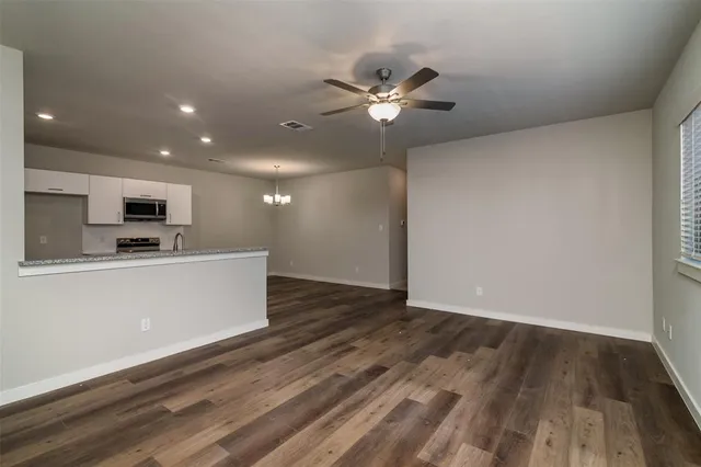 a view of kitchen with microwave and cabinets