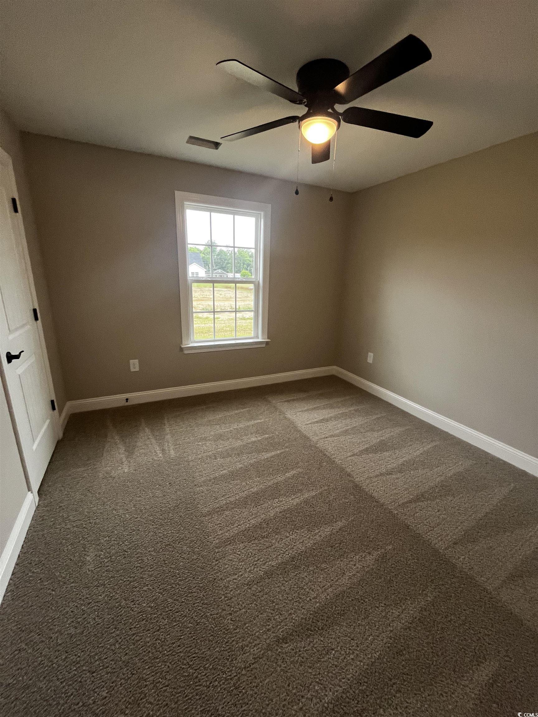 3424 Asbury Road Aynor, SC 29511 - Photo 6 of 10 Carpeted spare room with baseboards and ceiling fa