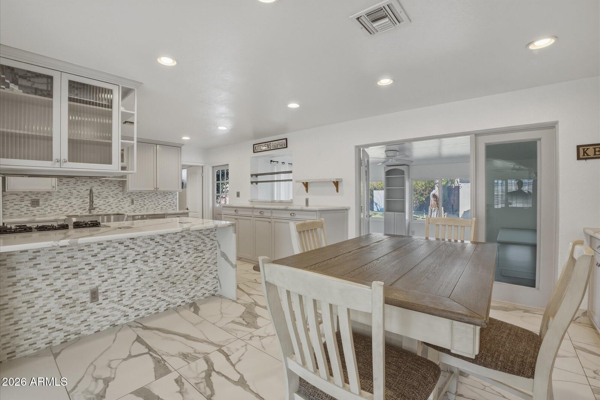 1532 West Loma Lane Phoenix, AZ 85021 - Photo 6 of 19 a kitchen with counter top space cabinets and wooden floor
