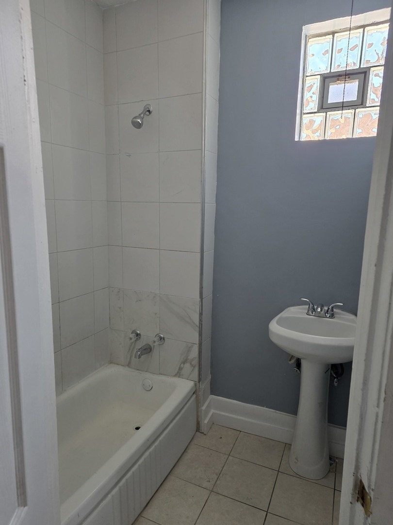 1853 East 79th Street, Unit 2 Chicago, IL 60649 - Photo 14 of 14 a bathroom with a sink a toilet and bathtub