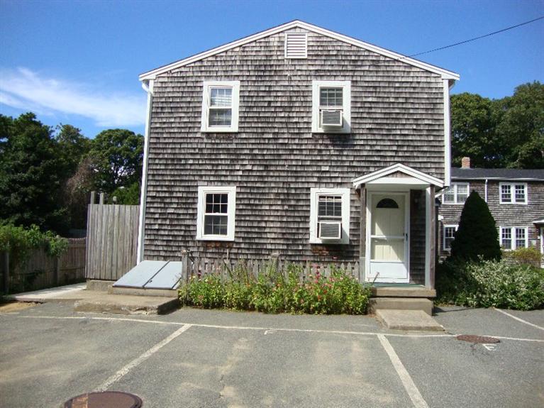 67 Inman Road, Unit F Dennis Port, MA 02639 - Photo 3 of 11 a front view of a house with a yard