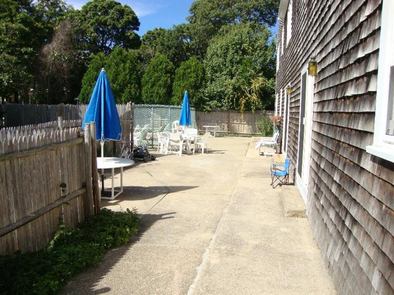67 Inman Road, Unit F Dennis Port, MA 02639 - Photo 4 of 11 a view of backyard with a patio and outdoor seating