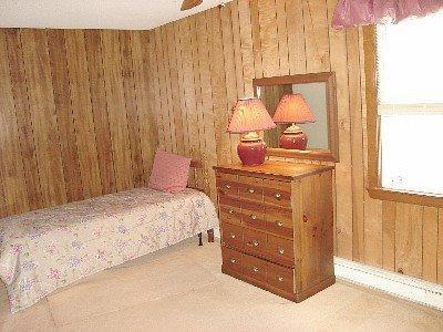 67 Inman Road, Unit F Dennis Port, MA 02639 - Photo 8 of 11 a bedroom with a bed and a window