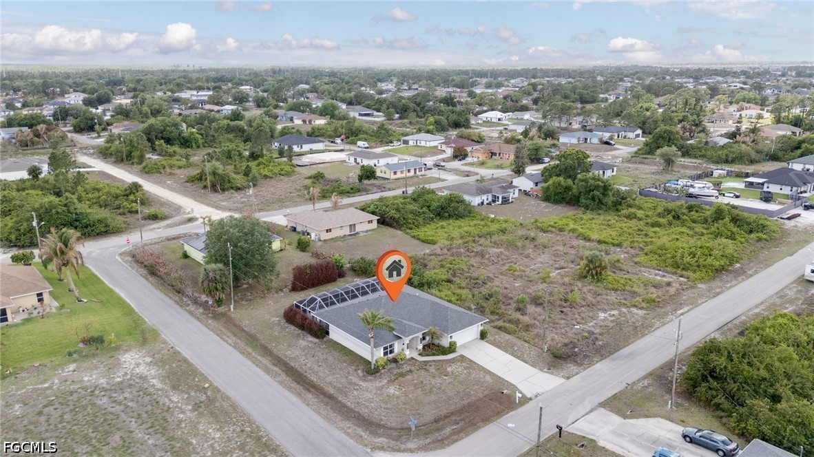 3801 28th Street Southwest Lehigh Acres, FL 33976 - Photo 31 of 37 an aerial view of a house with a garden and mountain view in back
