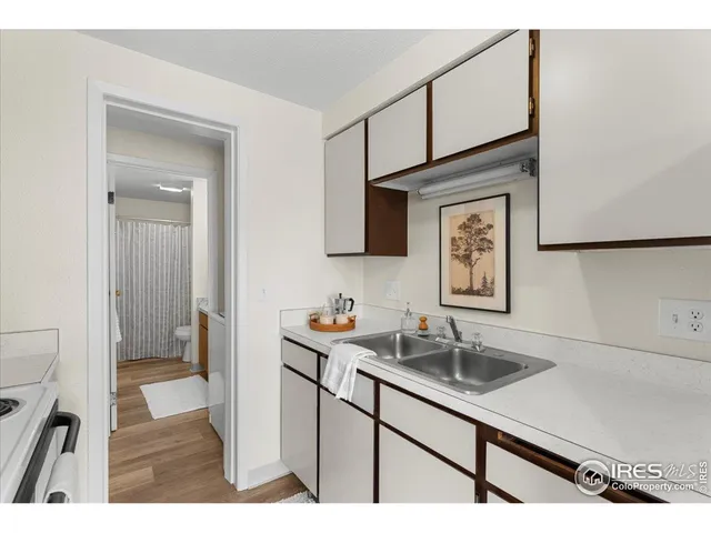 a kitchen with kitchen island a sink stove top oven and cabinets