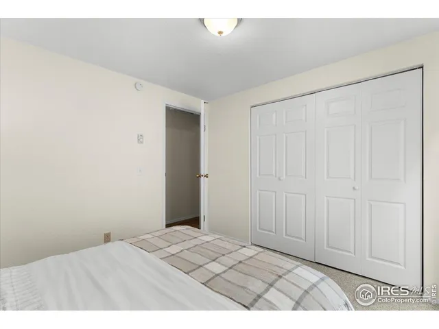 a bedroom with a bed and a night stand