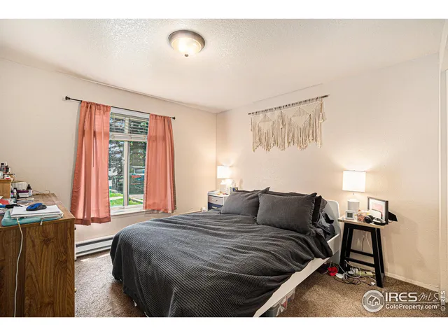 a bedroom with furniture and a window