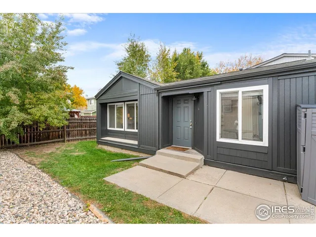 a view of a city street with a car parked on the road