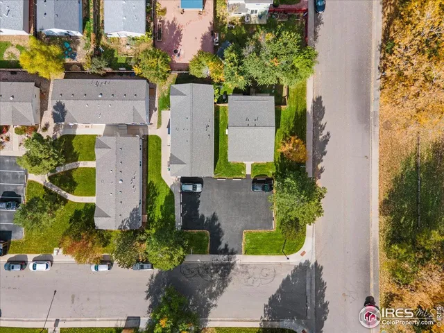 an aerial view of a house with a yard and trees