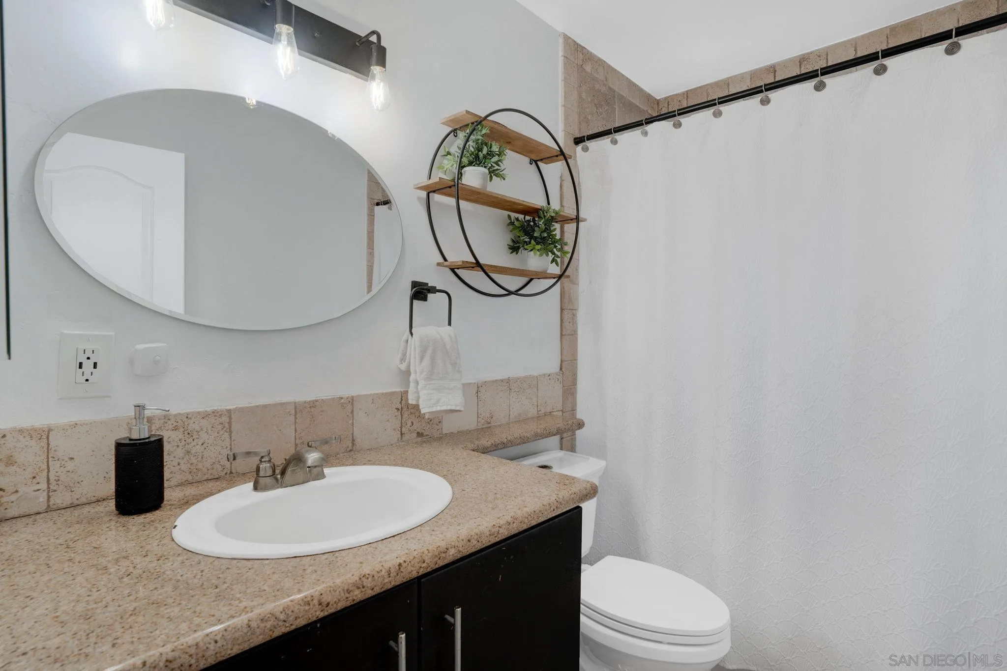 575 7th Street, Unit 104 Imperial Beach, CA 91932 - Photo 11 of 23 a bathroom with a sink vanity mirror and toilet