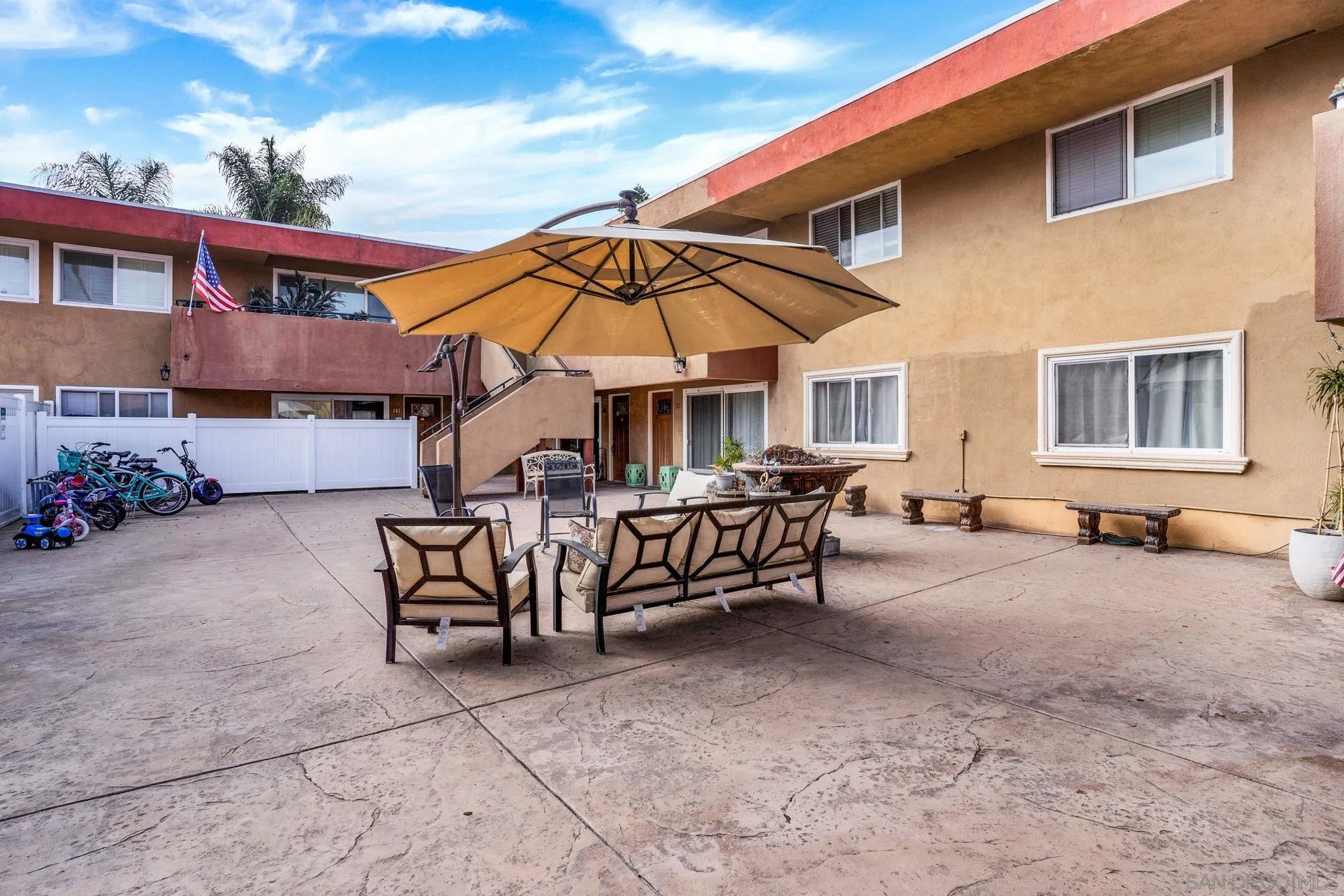 575 7th Street, Unit 104 Imperial Beach, CA 91932 - Photo 18 of 23 a view of a patio with a table and chairs under an umbrella
