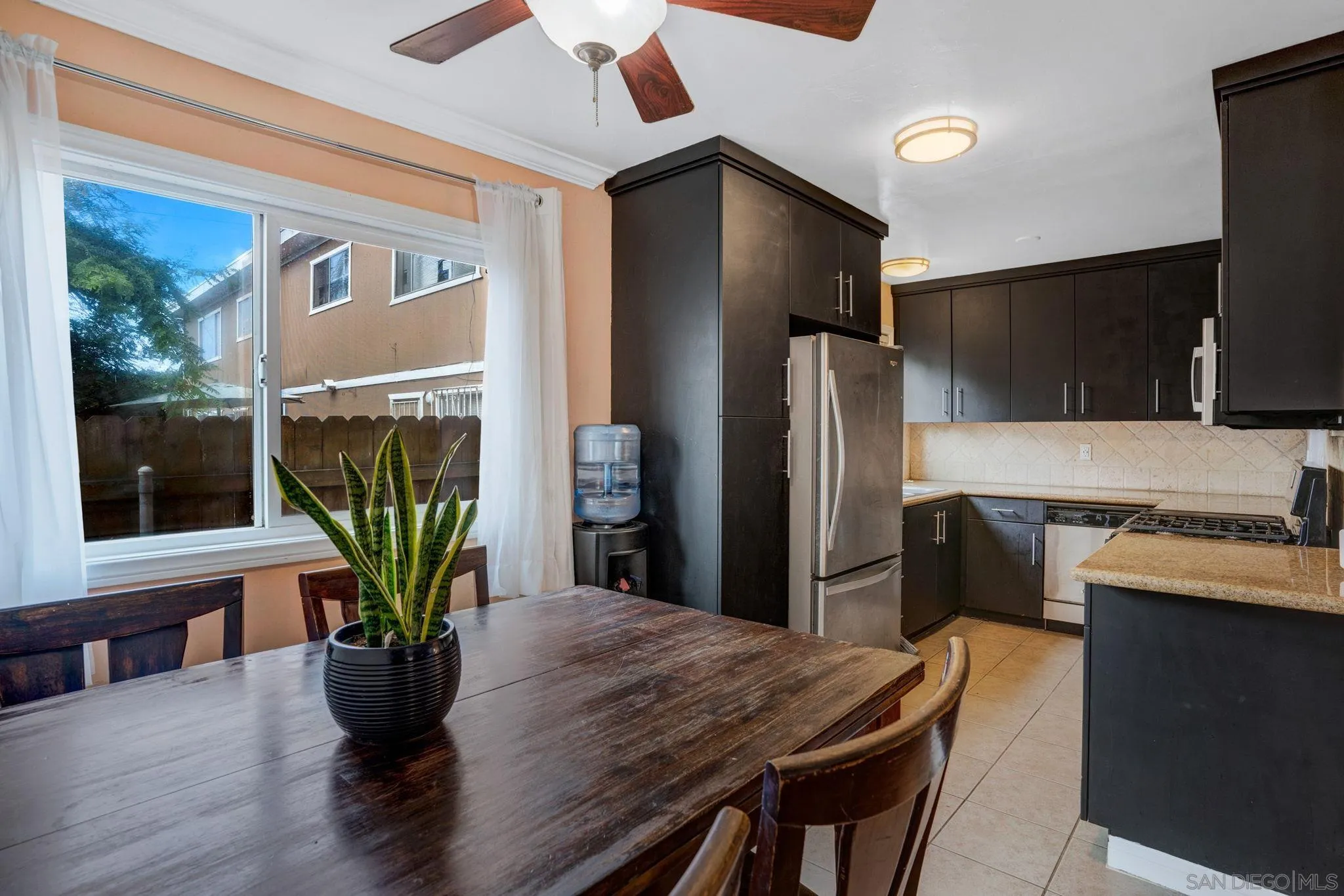 575 7th Street, Unit 104 Imperial Beach, CA 91932 - Photo 4 of 23 a kitchen with a table and stainless steel appliances