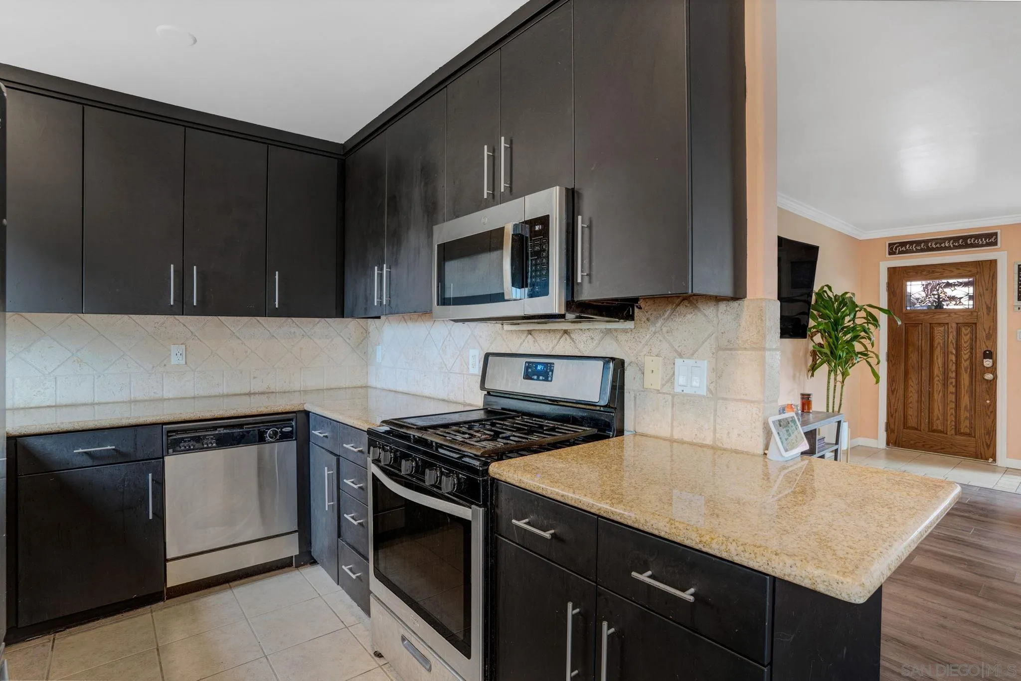 575 7th Street, Unit 104 Imperial Beach, CA 91932 - Photo 6 of 23 a kitchen with a sink stove and microwave