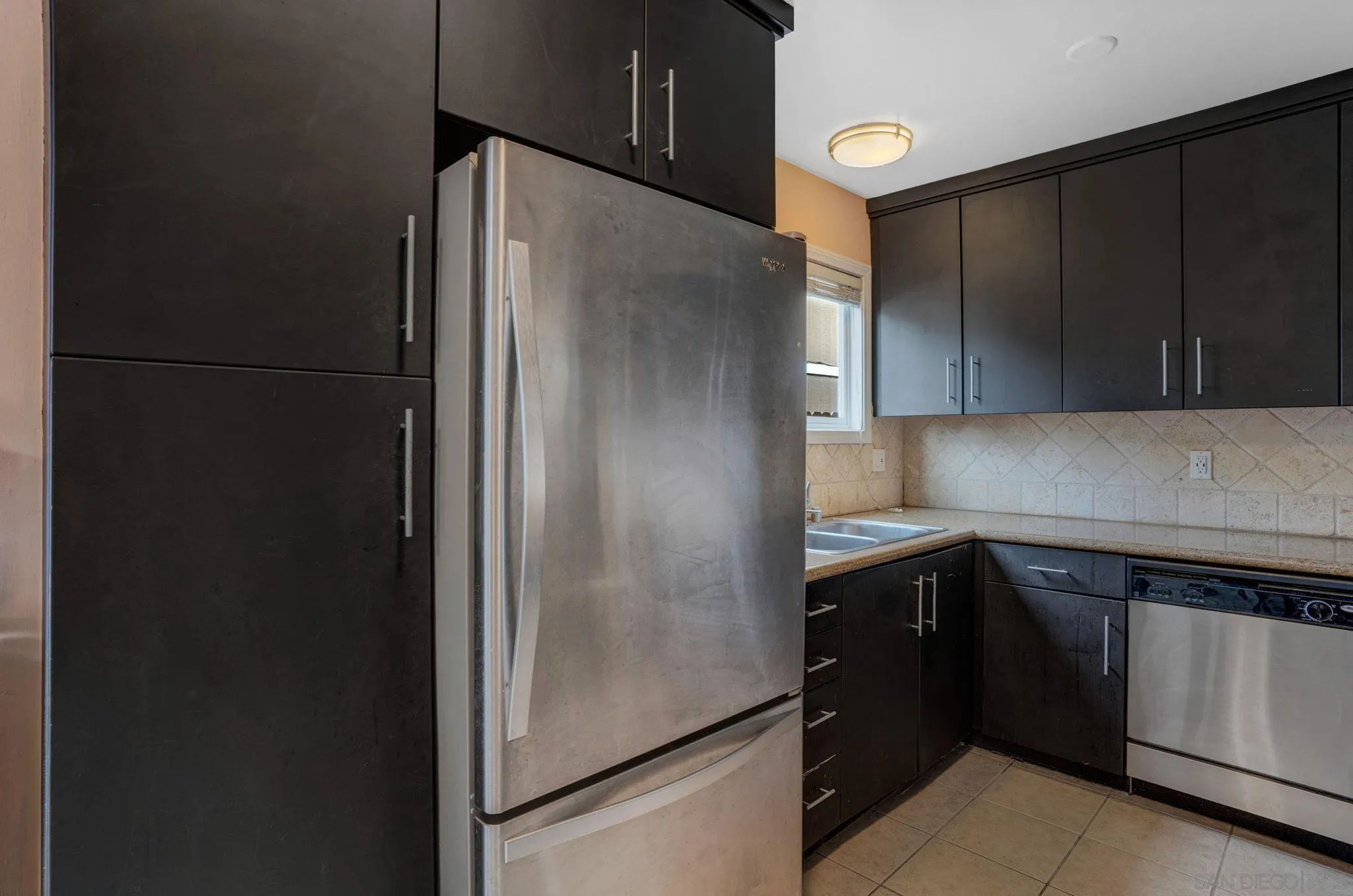 575 7th Street, Unit 104 Imperial Beach, CA 91932 - Photo 7 of 23 a kitchen with a refrigerator and a sink