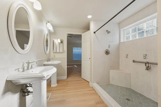 a spacious bathroom with a sink and a mirror