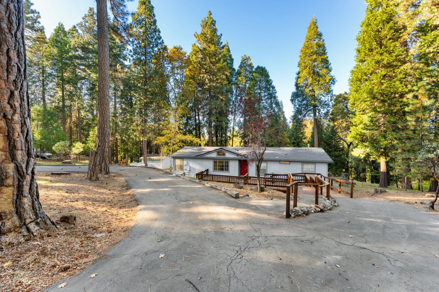 5819 Lynx Trail Pollock Pines, CA 95726 - Photo 25 of 34 a view of a patio with a table and chairs under an umbrella