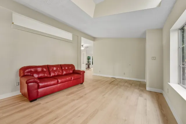 a living room with a couch and a wooden floor