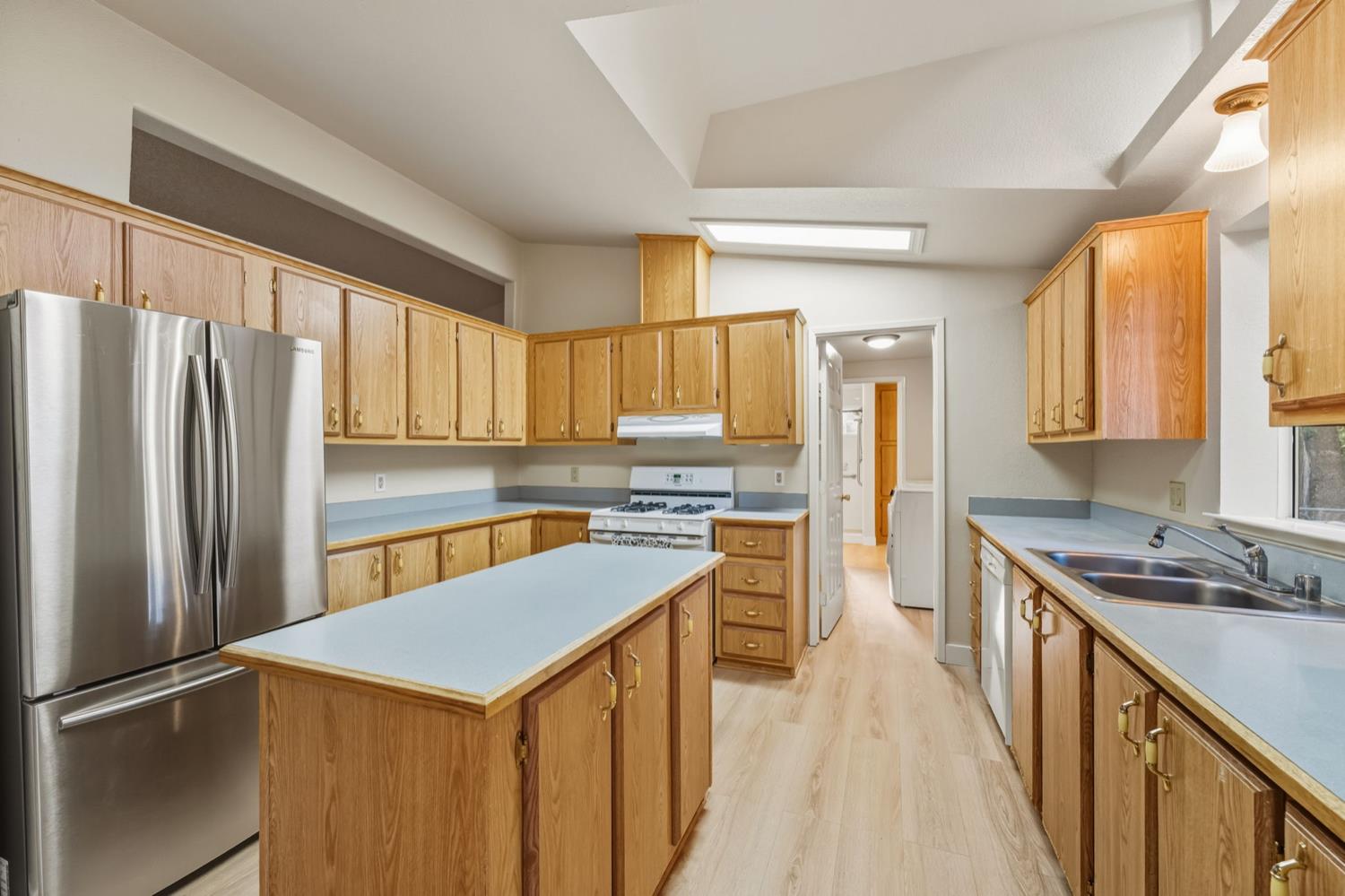 5819 Lynx Trail Pollock Pines, CA 95726 - Photo 6 of 34 a kitchen with stainless steel appliances granite countertop a refrigerator a sink dishwasher a stove and a refrigerator