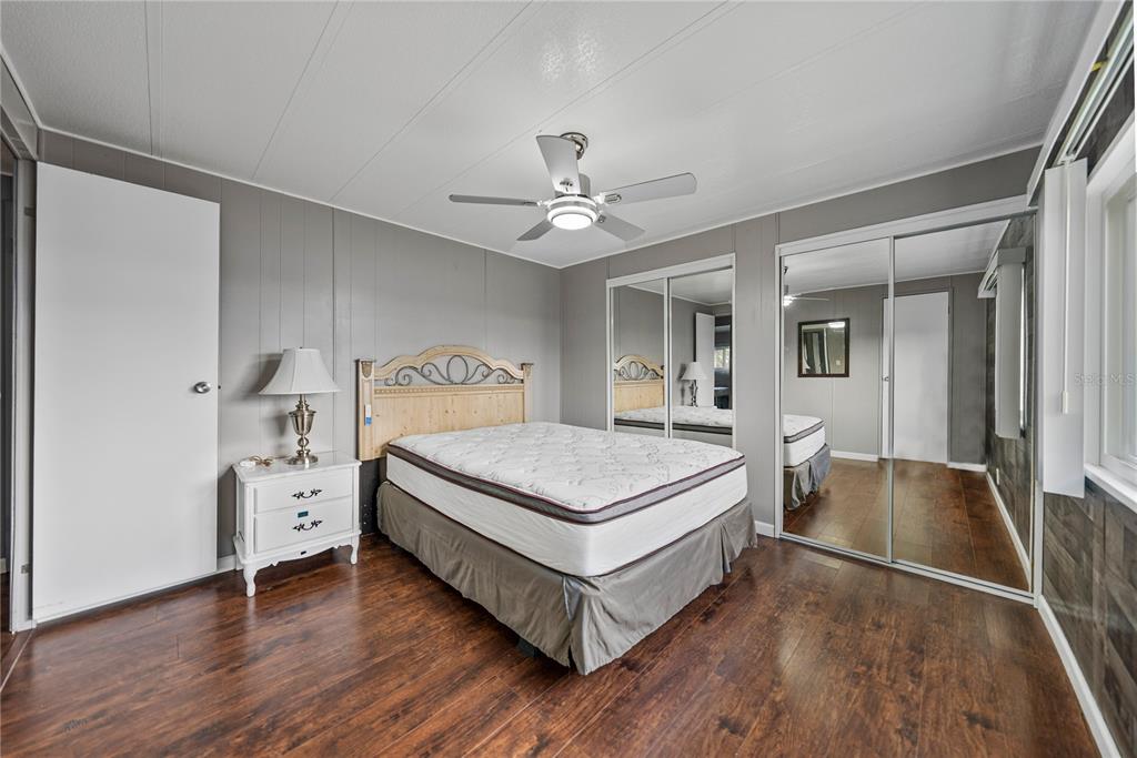 1610 Reynolds Road, Unit 72 Lakeland, FL 33801 - Photo 12 of 25 a bedroom with a bed and a chandelier