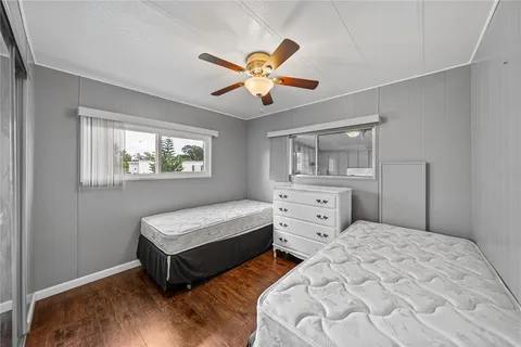 a bedroom with two beds and a chandelier