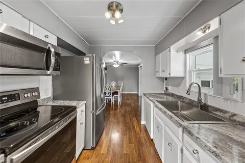 a kitchen with granite countertop a stove and a sink