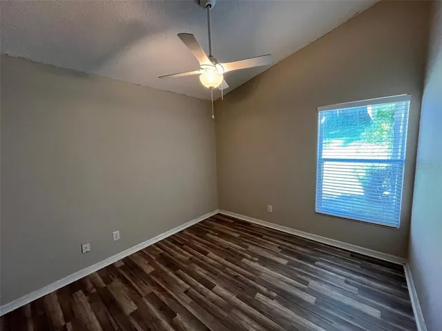 a view of a room with wooden floor and fan