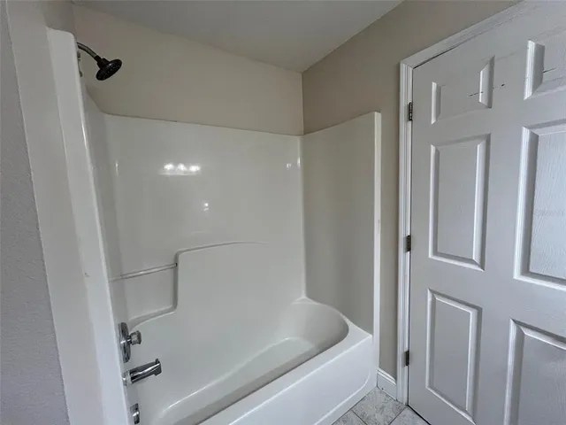 a bathroom with a shower and a tub