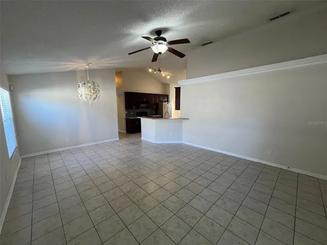 a view of a livingroom with a ceiling fan and window