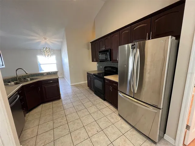 a kitchen with stainless steel appliances a refrigerator and a sink