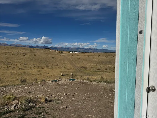 a view of a dry yard with wooden fence