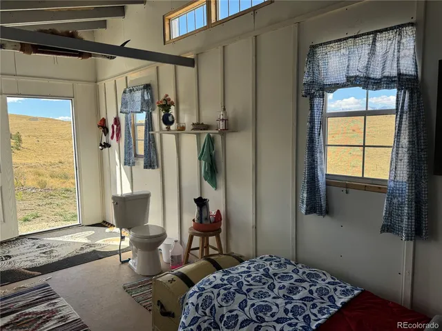 a bedroom with a bed and a television