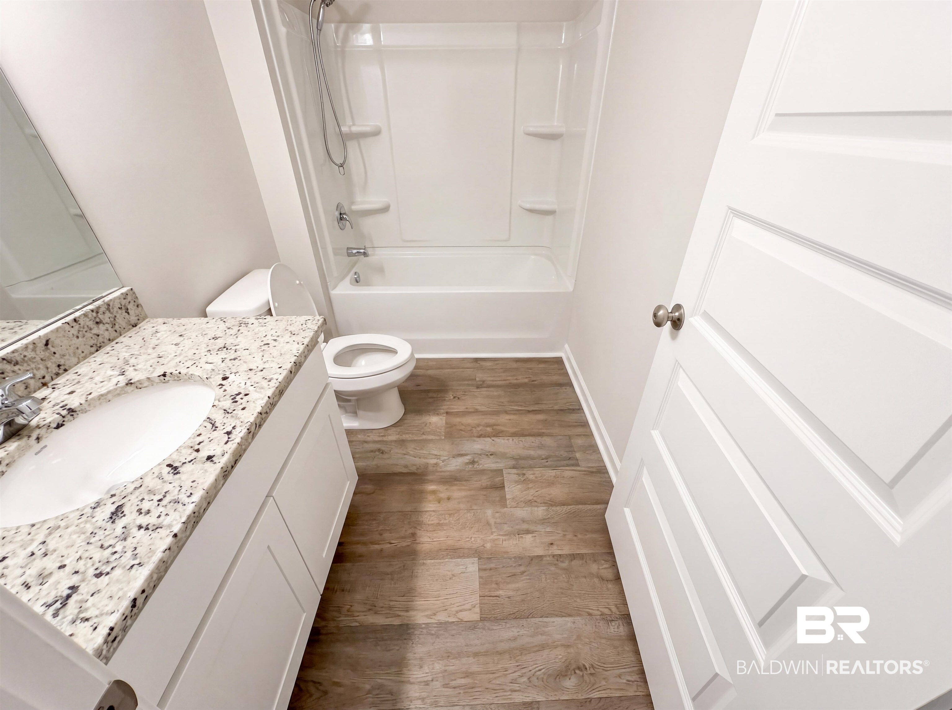 7453 Brompton Drive Foley, AL 36535 - Photo 14 of 15 Bathroom with a single vanity, undermount sink, and speckled stone countertop