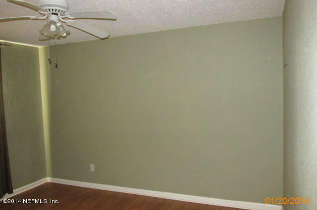 5213 Sunderland Road Jacksonville, FL 32210 - Photo 2 of 6 en empty room with a window and wooden floor