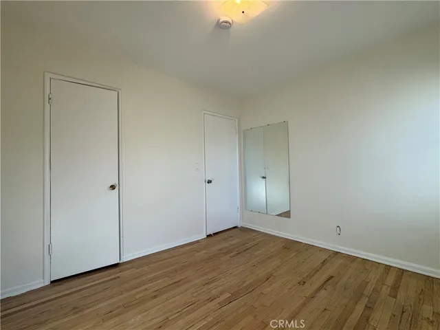 a view of wooden floor and windows in a room