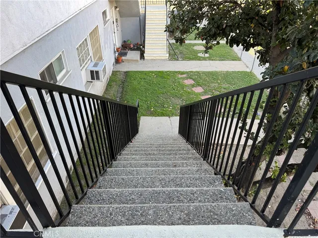 a view of a porch with wooden floor and fence