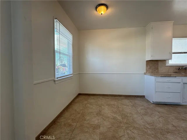 a view of a kitchen with an empty space and window