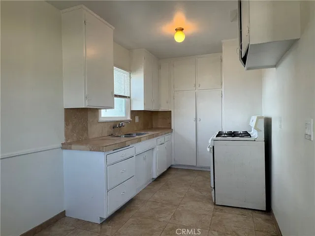 a kitchen with a stove and a refrigerator