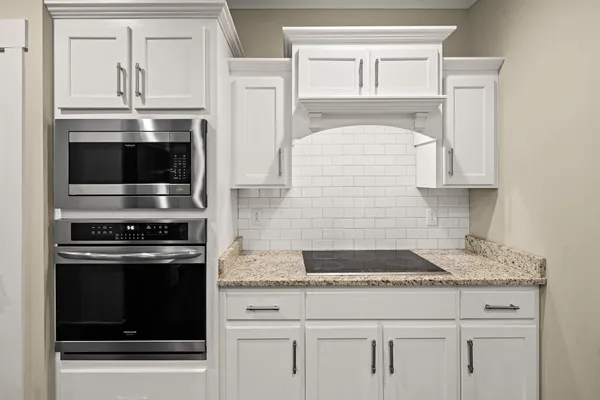 a bedroom with bed and a chandelier