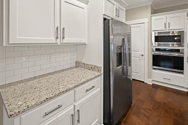 a bathroom with a granite countertop sink double and mirror