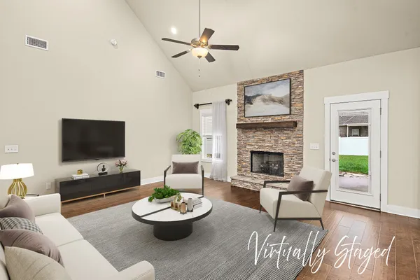 a living room with furniture a lamp and a flat screen tv