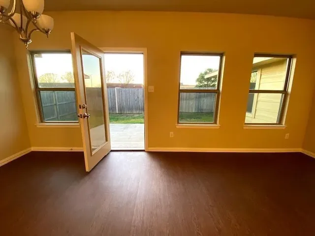 a living room with kitchen island furniture and a chandelier