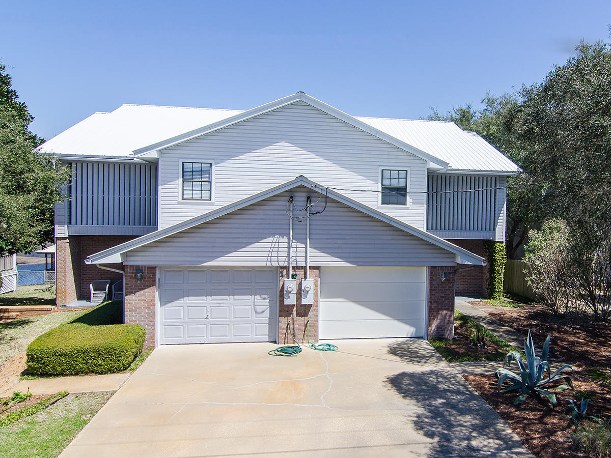 111 B Blue Lake Road Santa Rosa Beach, FL 32459 - Photo 31 of 34 a front view of a house with a yard and garage