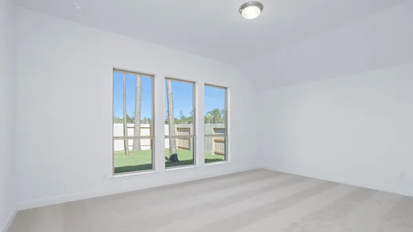 a spacious bathroom with a tub sink and mirror