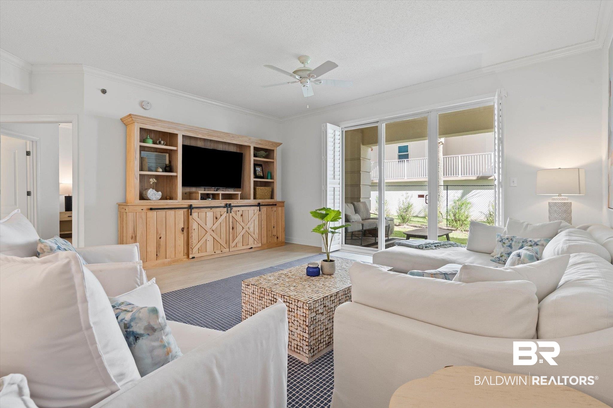 27770 Canal Road, Unit 2102 Orange Beach, AL 36561 - Photo 5 of 19 Living room with ornamental molding, wood finished floors, and a ceiling fan