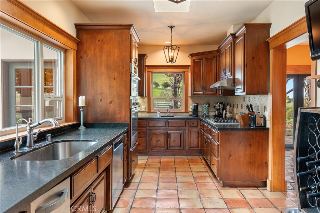 805 Spring Creek Way Templeton, CA 93465 - Photo 21 of 65 a kitchen with stainless steel appliances granite countertop a sink a stove and a wooden cabinets