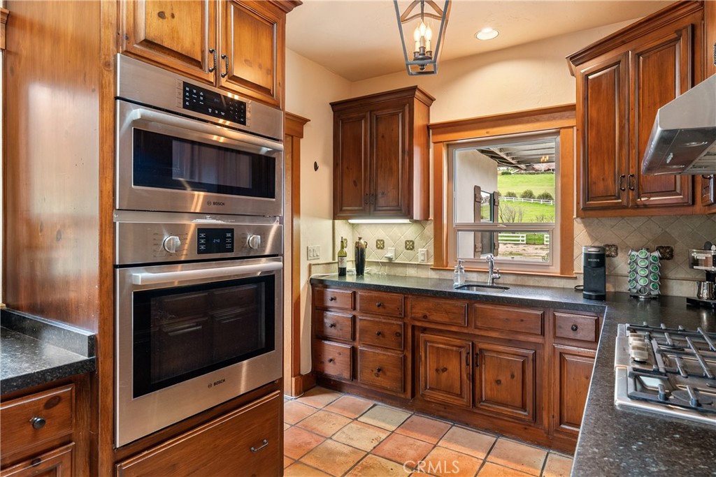 805 Spring Creek Way Templeton, CA 93465 - Photo 22 of 65 a kitchen with stainless steel appliances granite countertop a stove microwave and cabinets