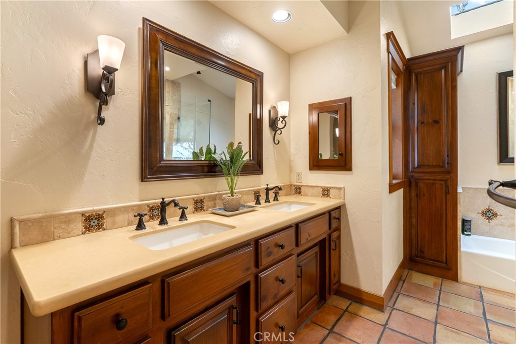 805 Spring Creek Way Templeton, CA 93465 - Photo 29 of 65 a bathroom with a sink and a mirror