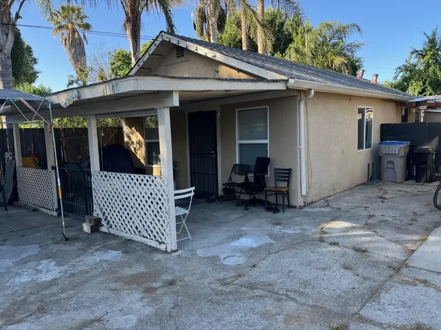 a view of a house with a porch and furniture